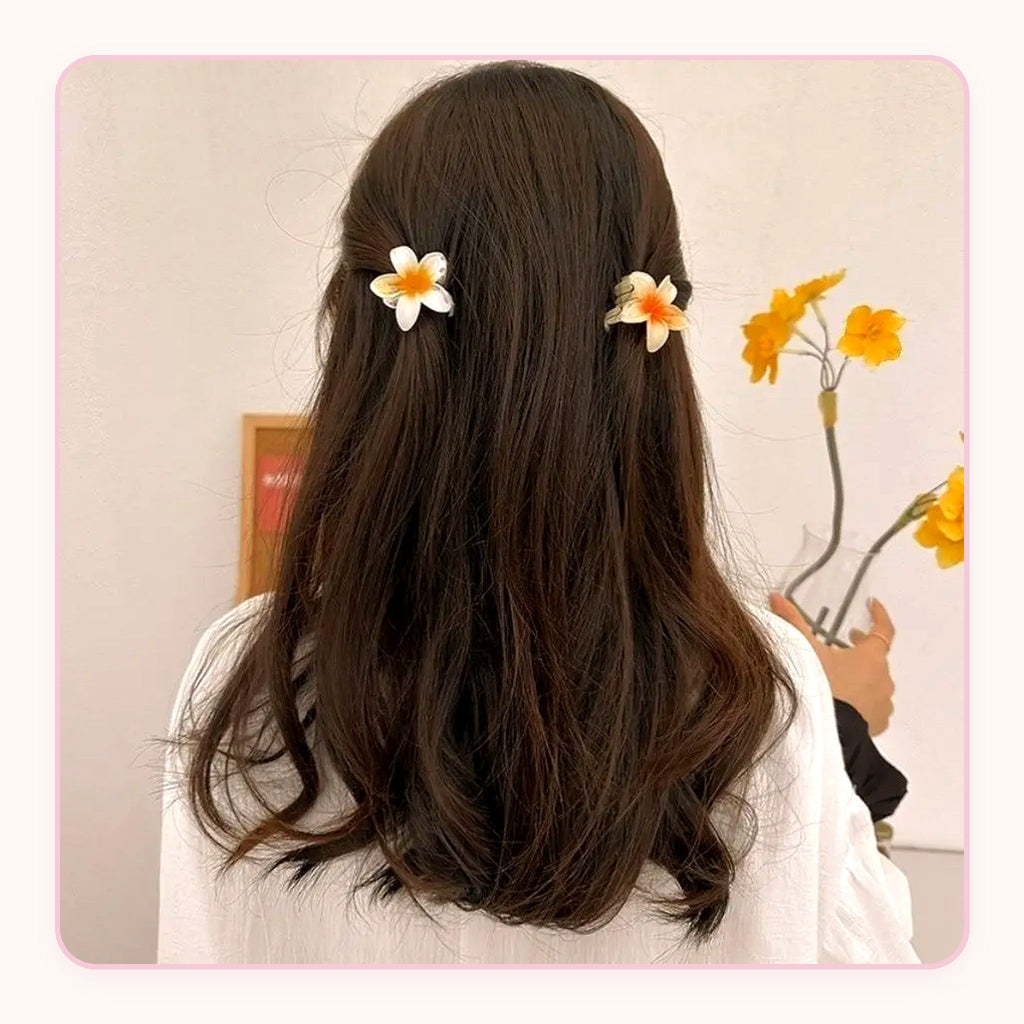 Six translucent plumeria flower claw clips in pastel colors