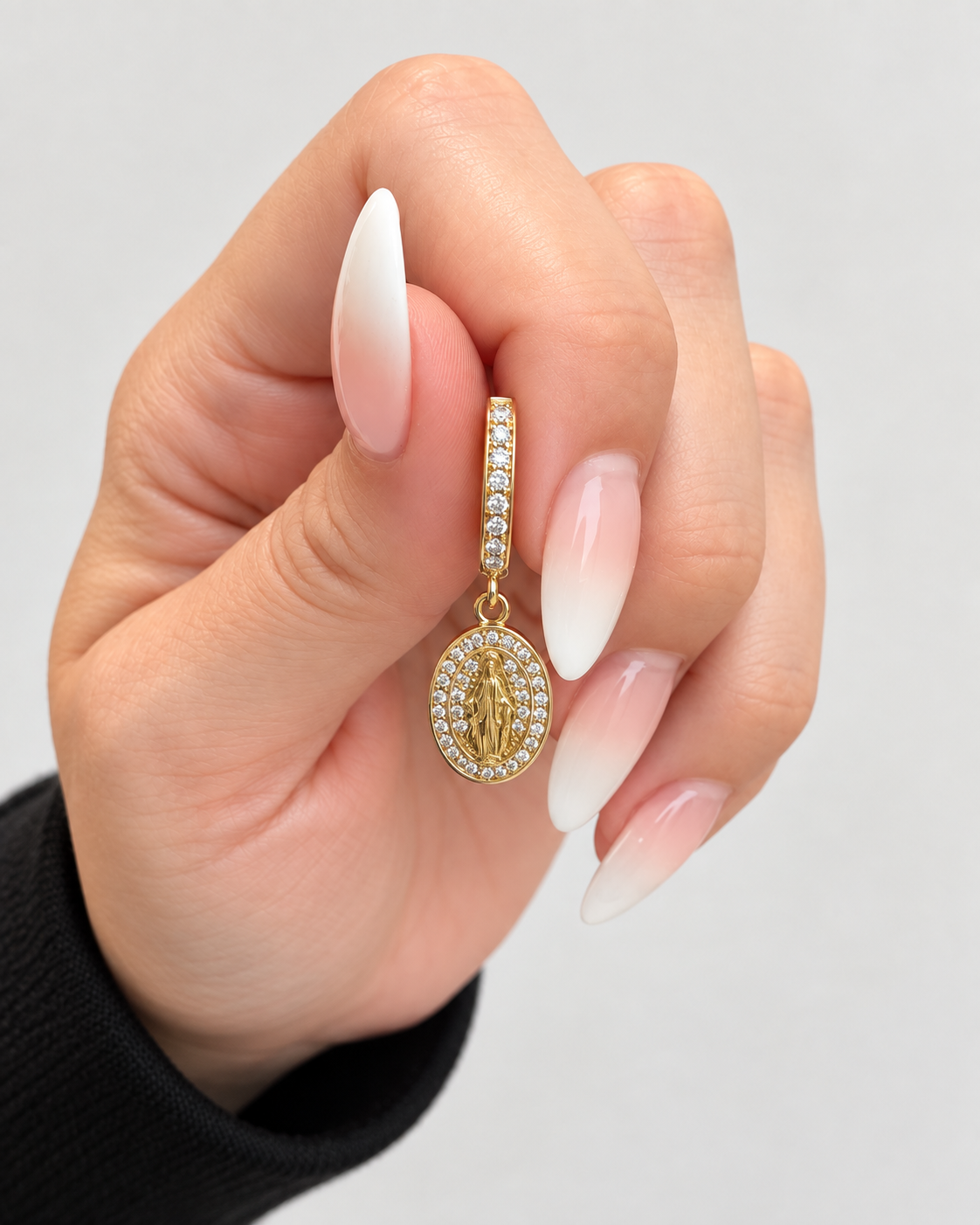 Gold huggie hoop earring with Virgin Mary medallion and clear stones