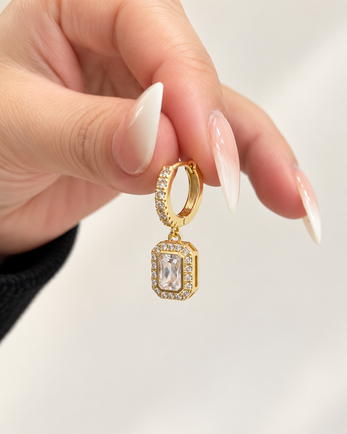 Gold pavé huggie earring with clear emerald-cut halo charm